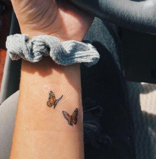 Two Small Flying Butterfly Couple Tattoo